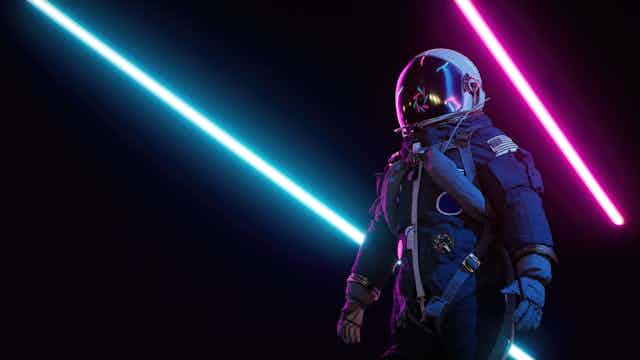 an astronaut stands in darkness with pink and blue neon strips in the background