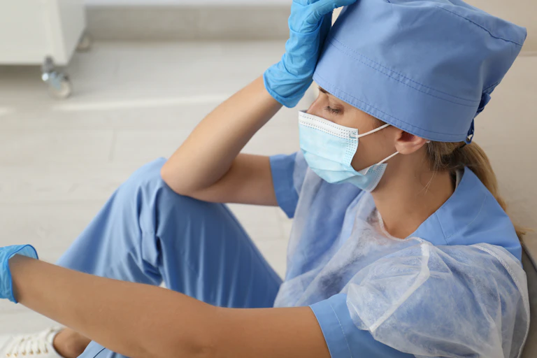 doctor sits exhausted