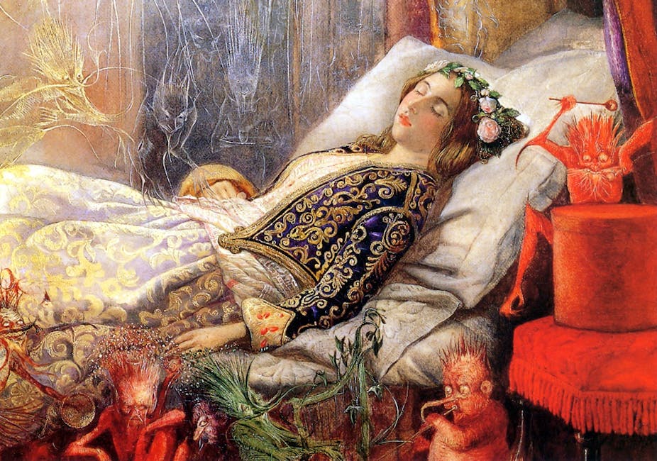 Woman sleeping surrounded by fairies.