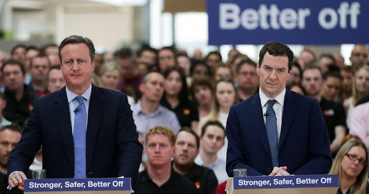 David Cameron and George Osborne giving a speech.