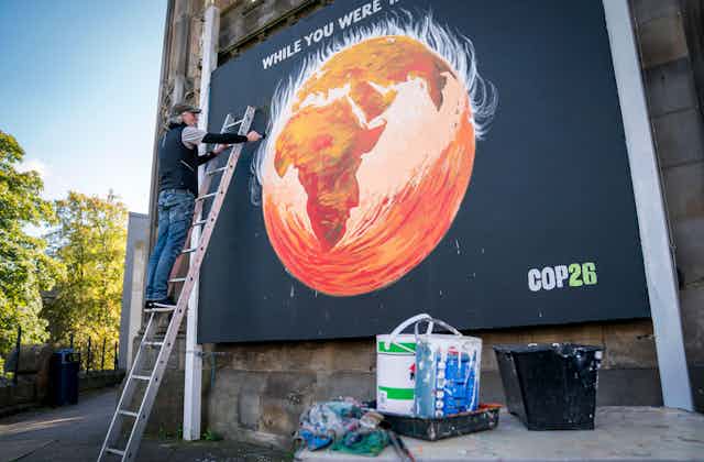 Man paints street art of world on fire