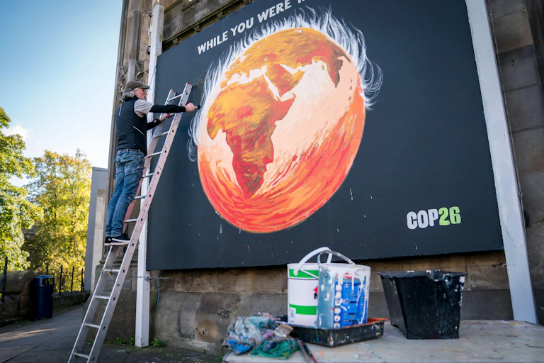 Man paints street art of world on fire