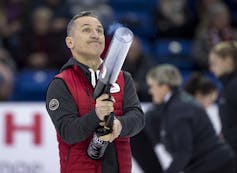 Elvis Stojko shoots T-shirts into a crowd from a plastic tube.