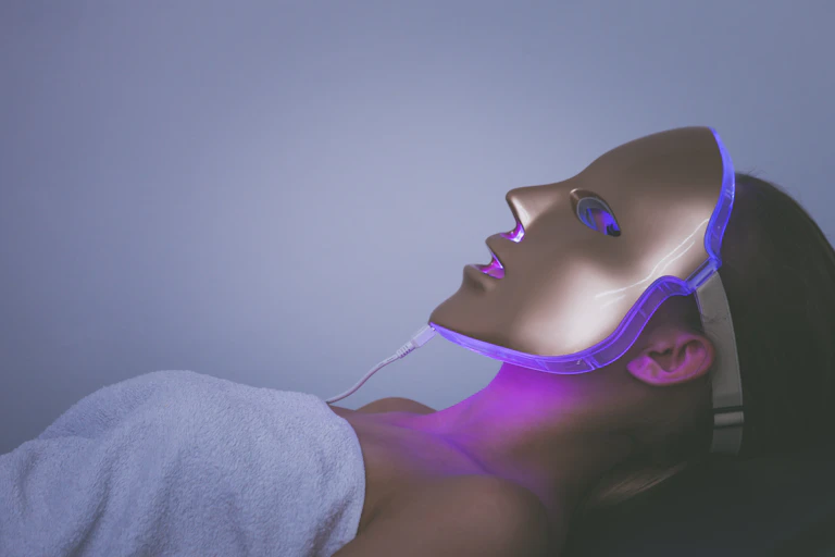 woman with lit face mask on