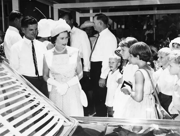 The Queen talks to young children.