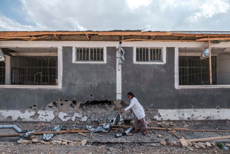 A nurse moves scrap from a damaged part of the Wukro General Hospital which was shelled, in Wukro, north of Mekele, on February 28, 2021.