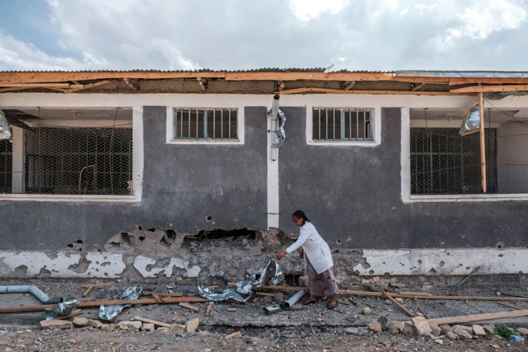 A nurse moves scrap from a damaged part of the Wukro General Hospital which was shelled, in Wukro, north of Mekele, on February 28, 2021.