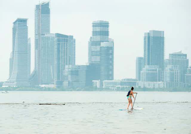 A woman paddle boarding in Lake Ontario.