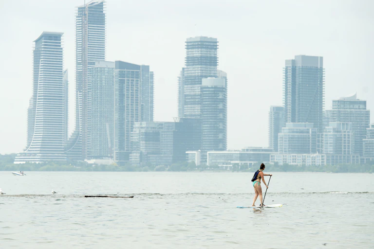 A woman paddle boarding in Lake Ontario.