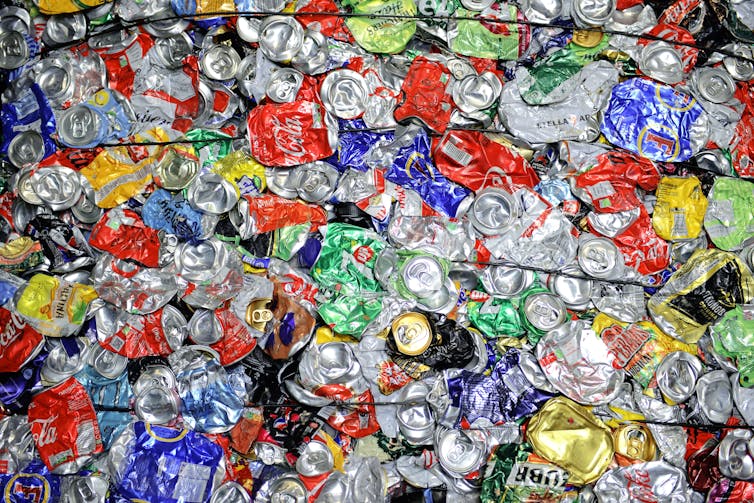Bale of squashed drink cans in a recycling facility