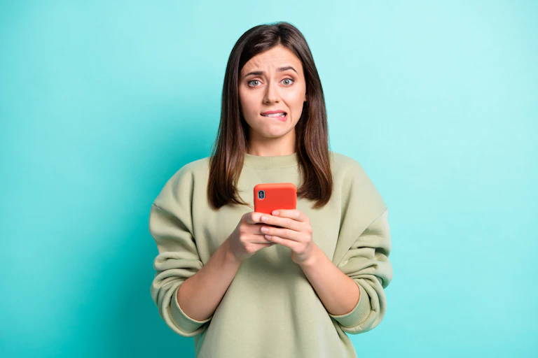 Anxious woman looking at smartphone