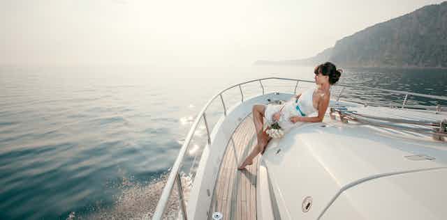 Woman lounging on luxury yacht.
