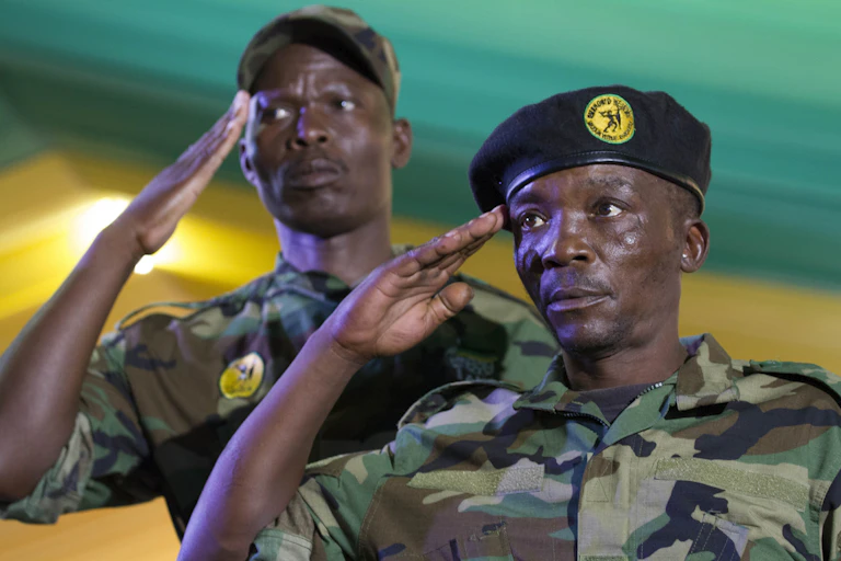 Army veterans in military uniform give the salute