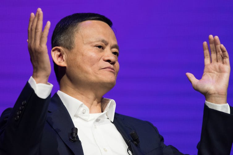 Jack Ma holding his hands up