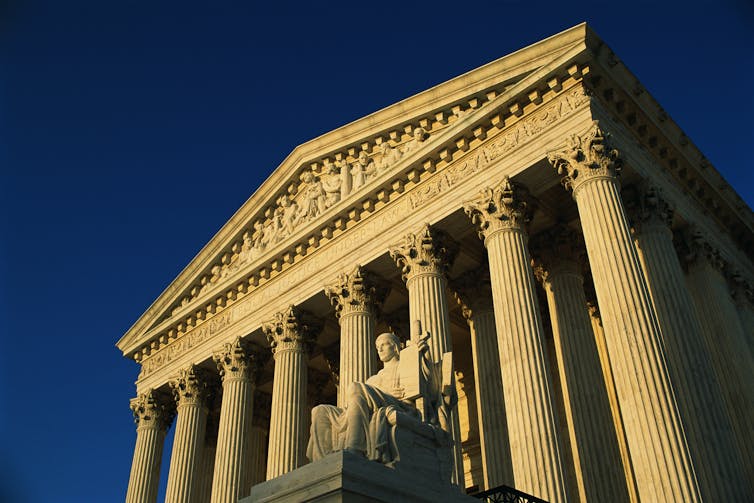 Majestic white courthouse with columns.