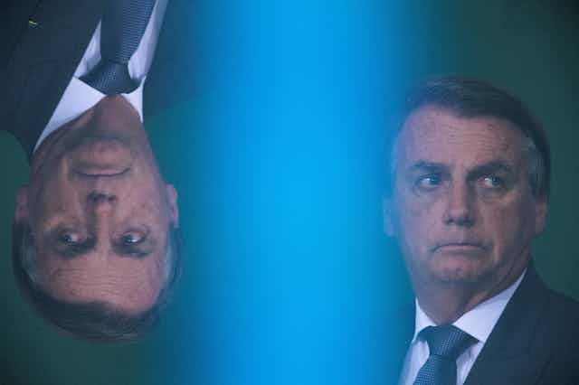 The same image of Jair Bolsonaro in profile side by side but one is upside down.