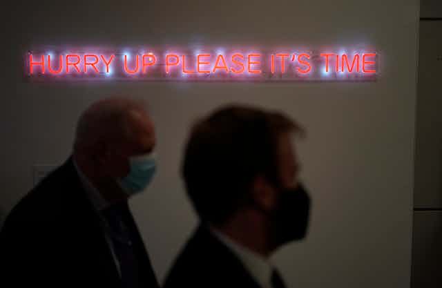 The illuminated words "Hurry up please it's time" are displayed at the COP26 U.N. Climate Summit, in Glasgow, Scotland,