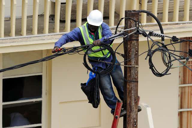 A worker on a utility pole