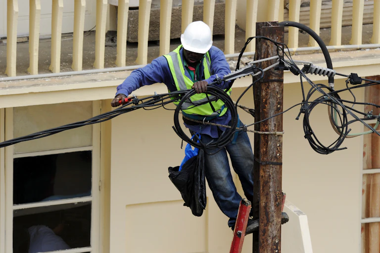 A worker on a utility pole