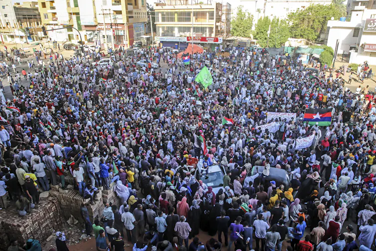 Thousands of Sudanese citizens mass in Khartoum to protest the military takeover.