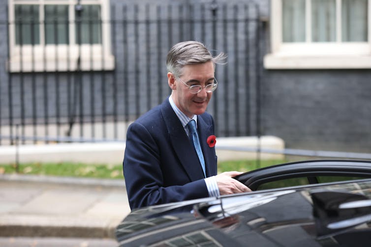 Jacob Rees Mogg getting into a car on Downing Street.