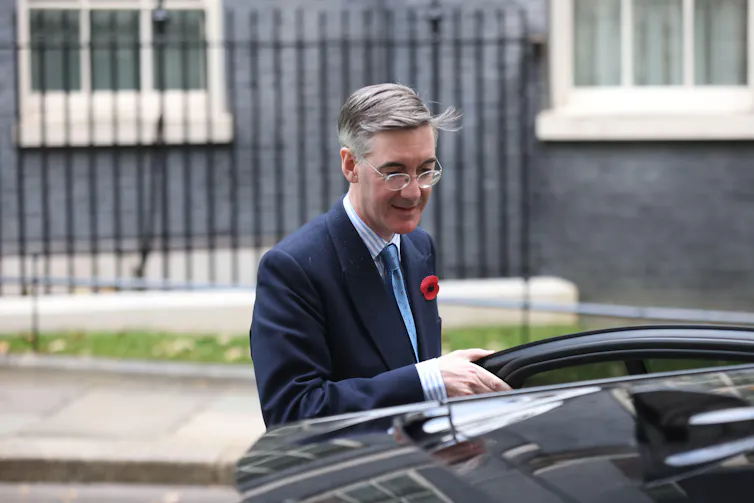 Jacob Rees Mogg getting into a car on Downing Street.