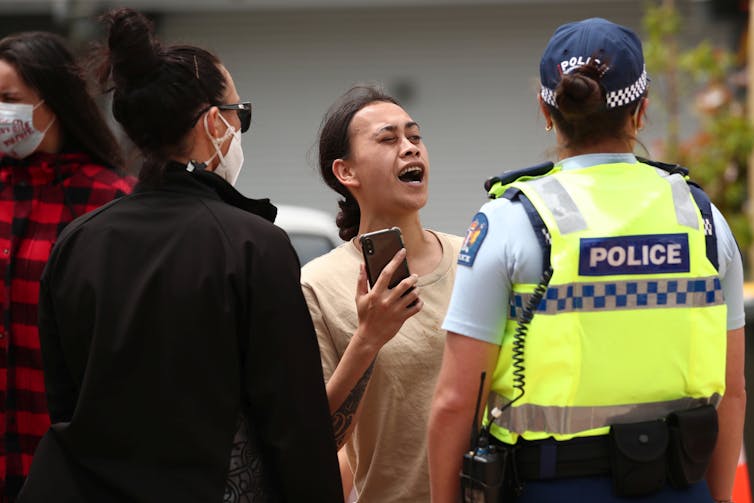 A protester at one of the events of Prime Minister Jacinda Ardern's tour of vaccination clinics.