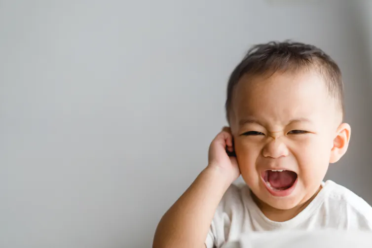 Young child in pain, clutching ear