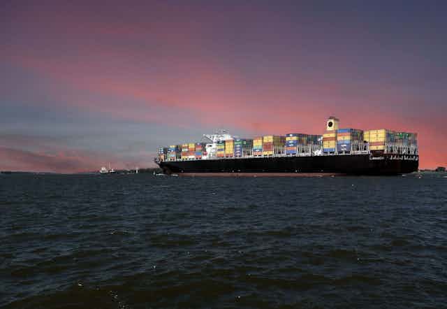 A container ship at dusk