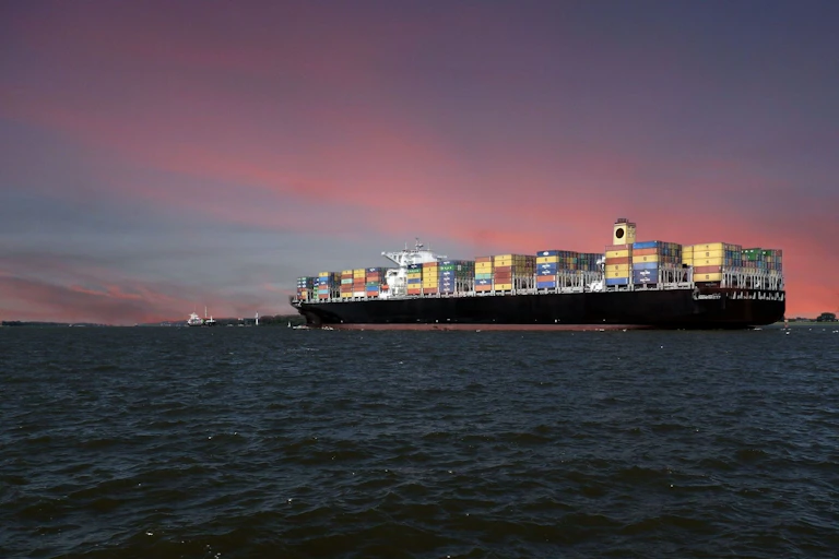 A container ship at dusk