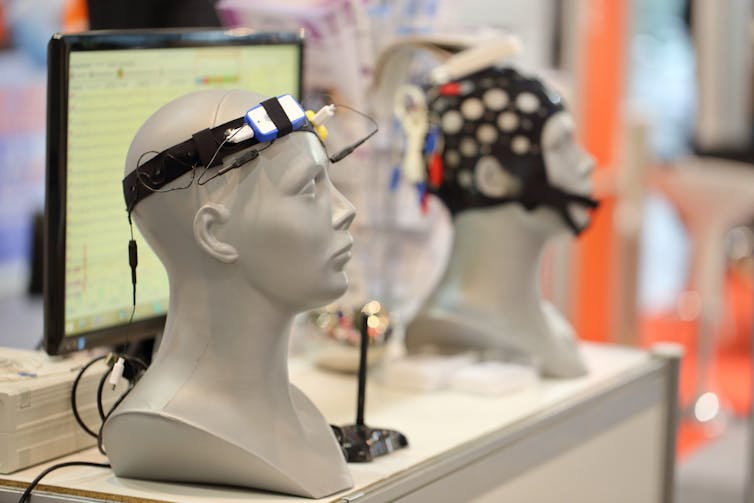 Two examples of EEG devices on mannequin heads.