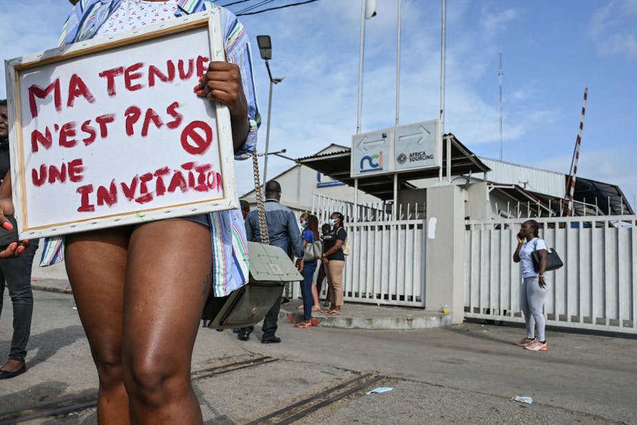 An activist holds a placard reading "my outfit is not an invitation" during a demonstration against the television channel Nouvelle Chaine Ivorienne (NCI) following a shocking programme on rape.