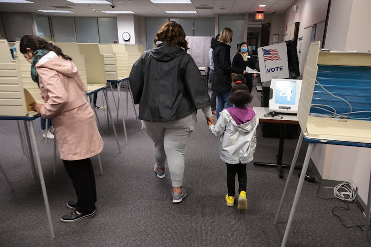 A woman leads a young child through a voting site in Virginia.