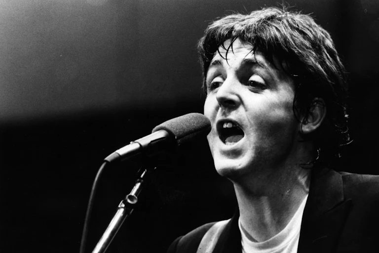Man sings in front of microphone.