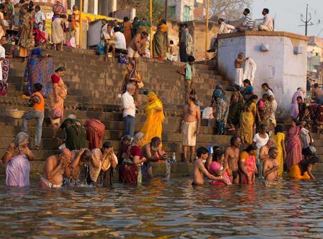  Bathing and Purification in the Ganges River at dawn - Varanasi, India. Studies have reported high pollution - fecal Stock Photo Download preview Save to lightbox Add to cart  Share   Bathing and Purification in the People bathing in the Ganges River, India