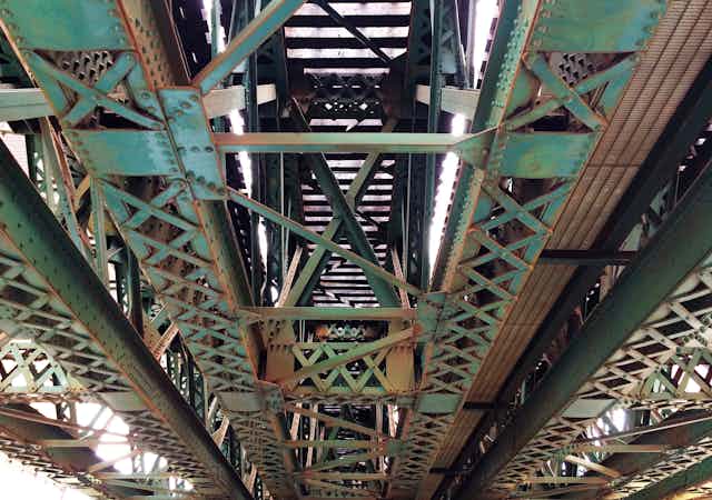 Rust on the underside of a metal bridge.