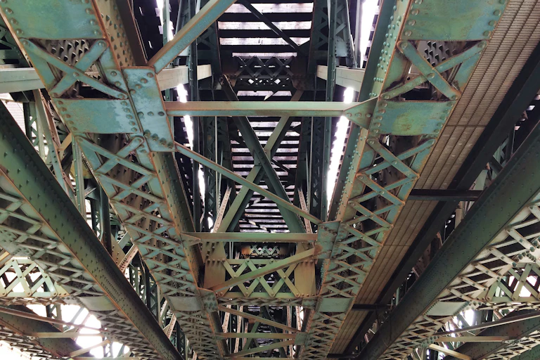 Rust on the underside of a metal bridge.