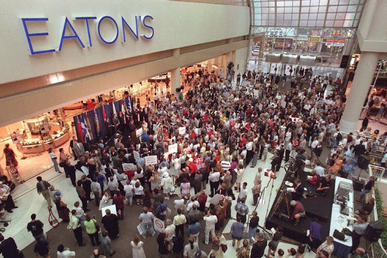 The Eaton's sign is seen above a gathering of hundreds of employees.