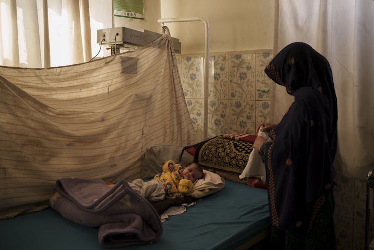 A baby in a hospital malnourished ward.