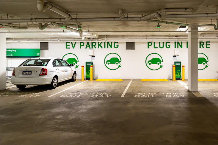white electric vehicle in almost empty parking bays