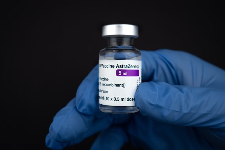 vial of vaccine in gloved hand