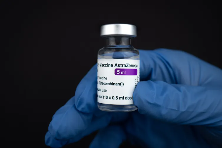 vial of vaccine in gloved hand