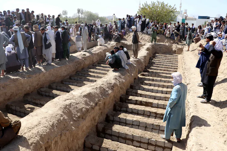 Preparing to bury victims of a bomb blast.