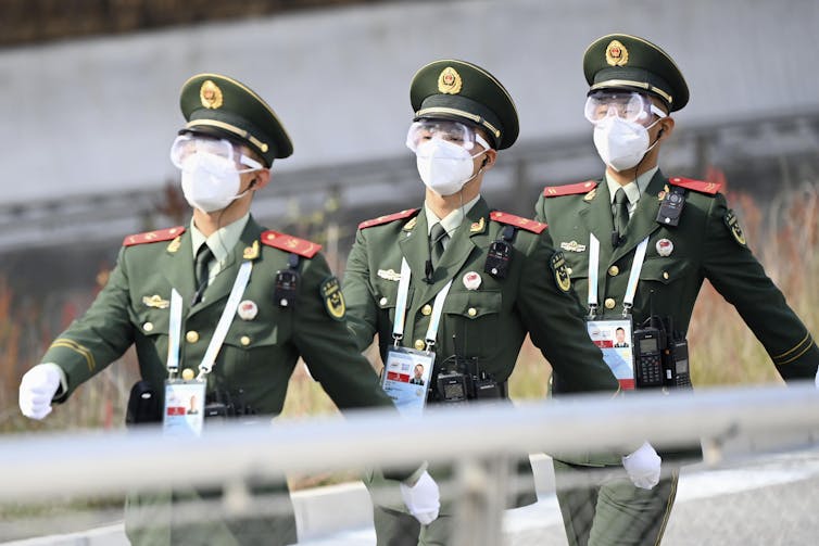 Chinese police patrol an Olympic venue in October 2021.