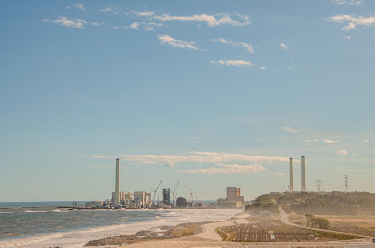 Beach with towers and buildings in the background