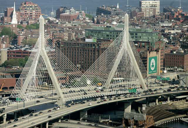 The Leonard P. Zakim Bunker Hill Bridge appears in front of the Boston skyline in this aerial photograph over Boston 