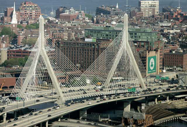 The Leonard P. Zakim Bunker Hill Bridge appears in front of the Boston skyline in this aerial photograph over Boston
