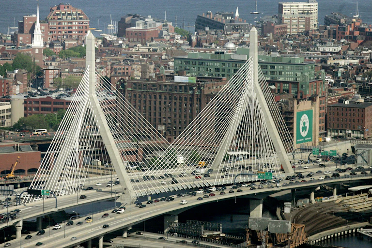 The Leonard P. Zakim Bunker Hill Bridge appears in front of the Boston skyline in this aerial photograph over Boston