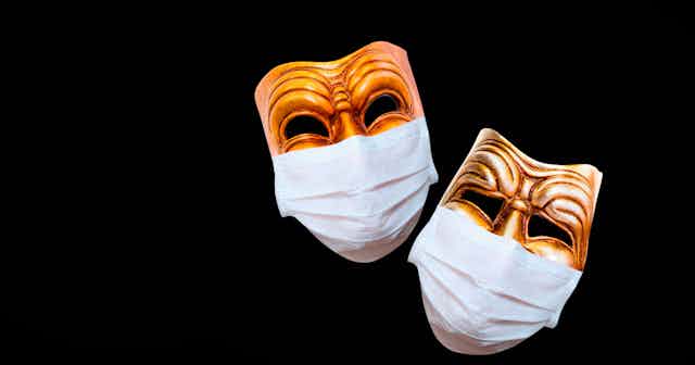 Two traditional drama commedia del'Arte masks covered in face masks.