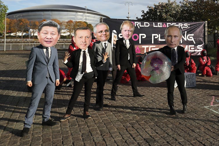 Climate campaigners dress up as world leaders including, from left, Chinese President Xi Jinping, Turkish President Recep Tayyip Erdogan, Russian President Vladimir Putin, Australian Prime Minister Scott Morrison.
